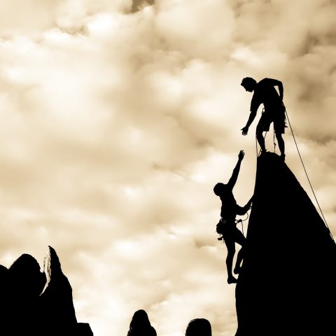Climbers working together on a difficult ascent